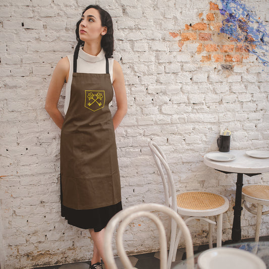 The Inheritance Crest in Brown Apron